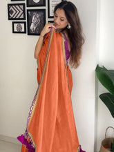 Modern Orange Satin-Finish Saree with Purple Sleeveless Blouse & Tassel Detail