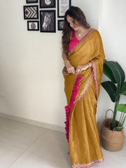 Elegant Mustard Gold Silk Saree with Magenta Contrast Border and Pom-Pom Tassel Detail