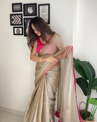 Shimmering Champagne Tissue Silk Saree with Rani Pink Scalloped Embroidery and Tassel Detail