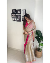 Shimmering Champagne Tissue Silk Saree with Rani Pink Scalloped Embroidery and Tassel Detail