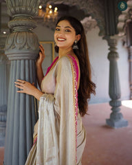 Shimmering Champagne Tissue Silk Saree with Rani Pink Scalloped Embroidery and Tassel Detail