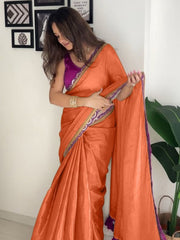 Modern Orange Satin-Finish Saree with Purple Sleeveless Blouse & Tassel Detail